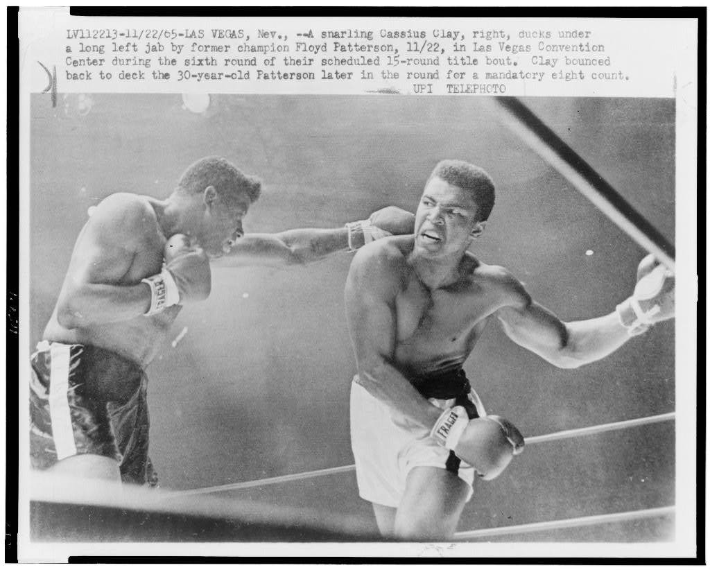 Muhammad Ali ducks a left jab from Floyd Patterson during their 1965 title fight inside the Las Vegas Convention Center, UPI wire photo