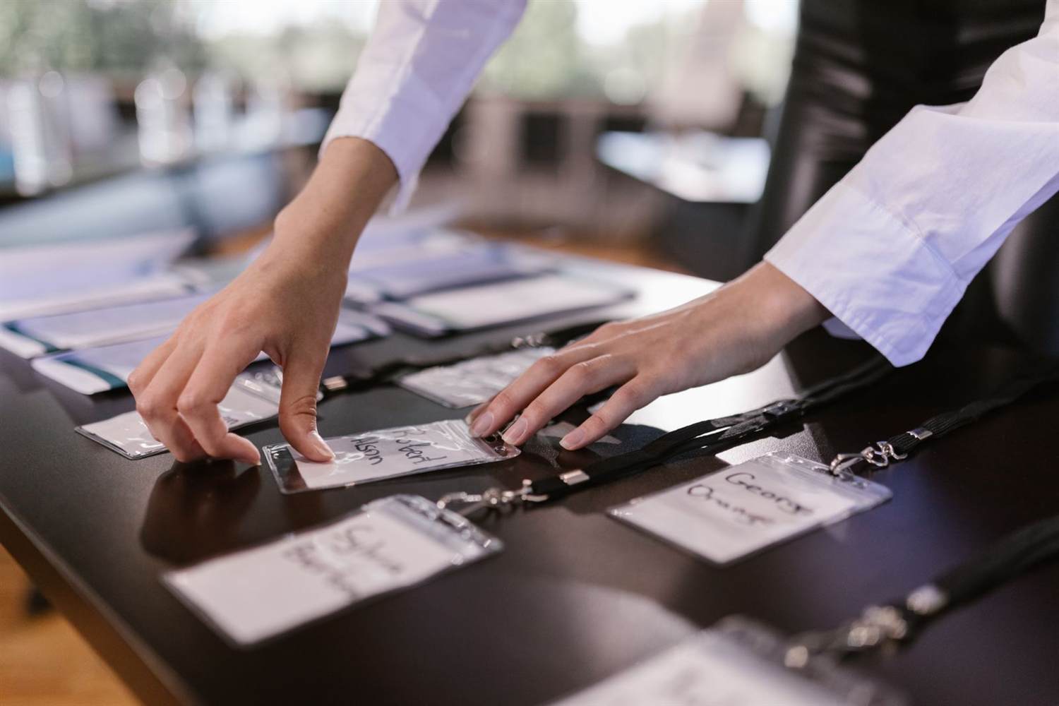 Conference badges laid out on a registration table