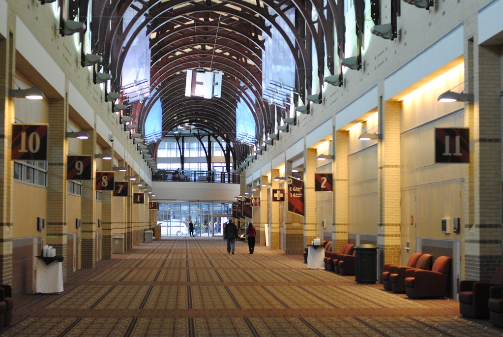 The arched, skylit main concourse of the Chattanooga Convention Center lined with numbered meeting rooms