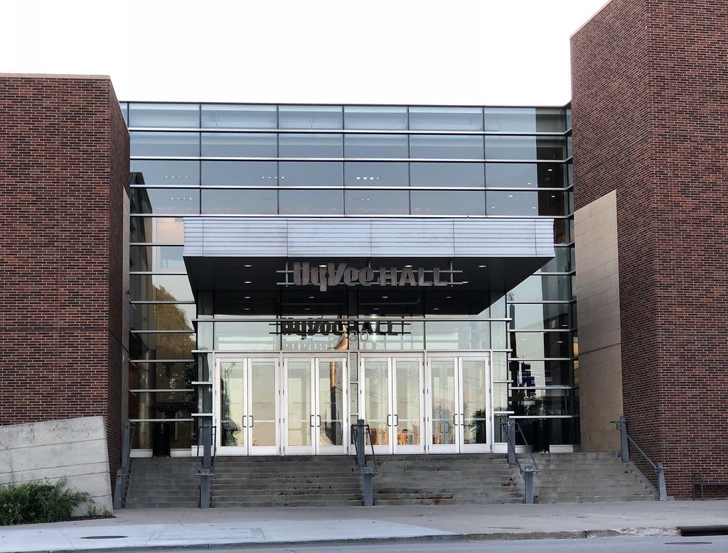 The glass entrance of Hy-Vee Hall, now the EMC Expo Center, between two red-brick towers at the top of a wide flight of steps