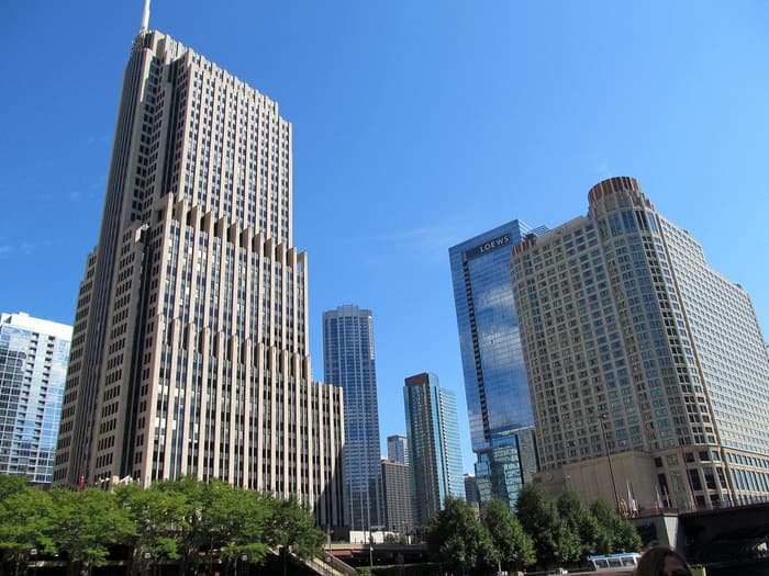 The rounded cream tower of the Sheraton Grand Chicago at right, beside the glass Loews tower and the setback NBC Tower, seen from the Chicago River