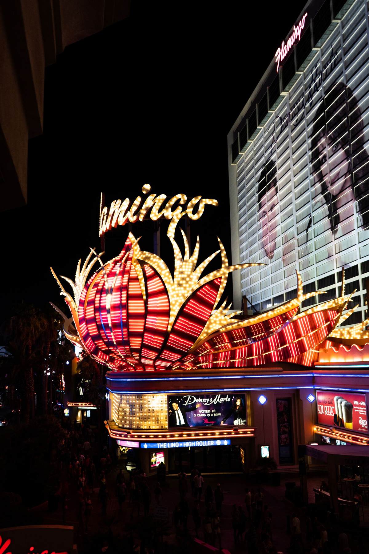 The neon Flamingo marquee lit at night on the Strip