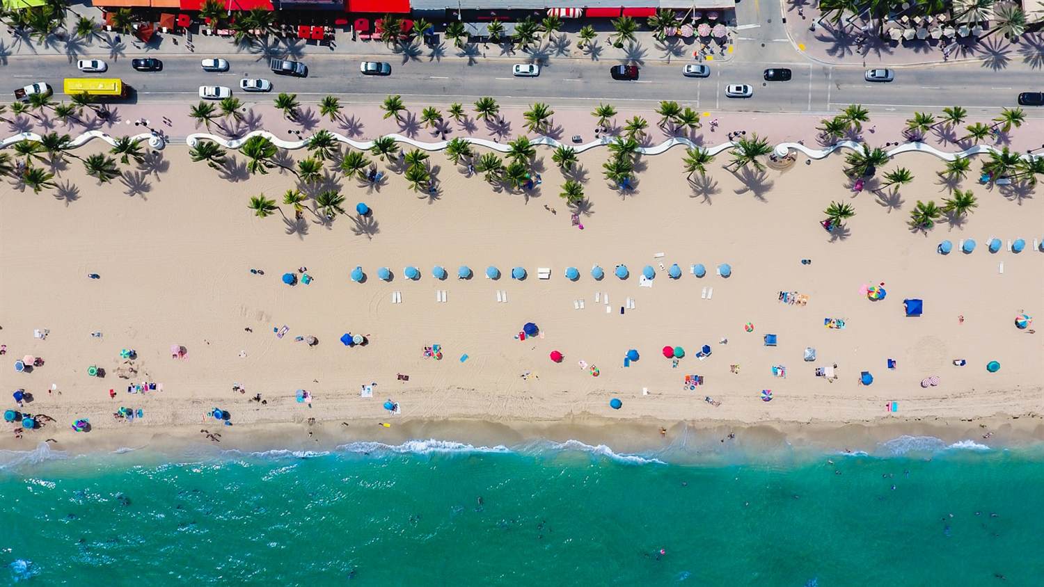 Aerial view of the Fort Lauderdale coastline with beachgoers and the A1A strip