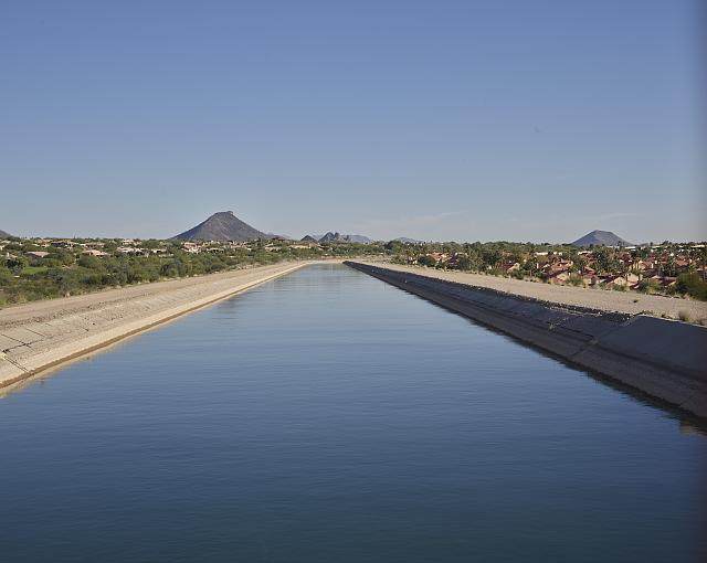 The Arizona Canal passing through Scottsdale, Arizona, lined with palm trees