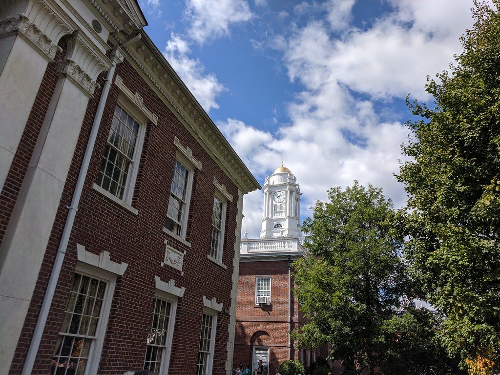 Brick colonial-style buildings with white trim and a white clock cupola on the Big E grounds