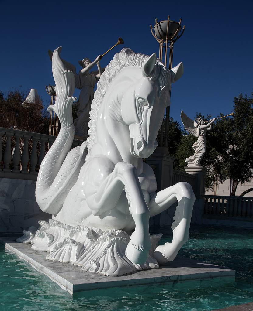 A white winged horse statue in a fountain at Caesars Palace