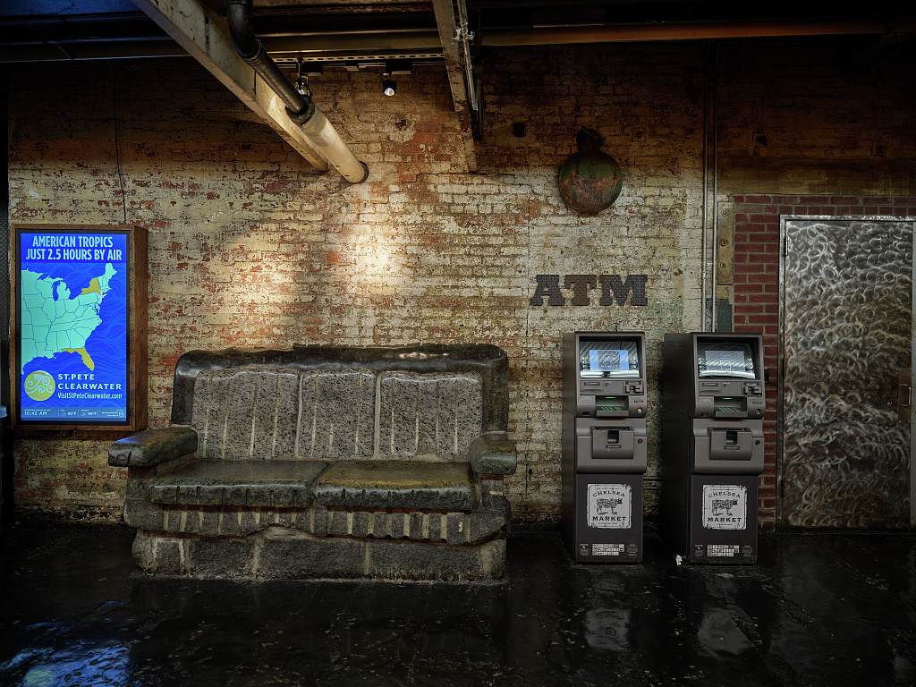 A hallway inside Chelsea Market lined with food shops