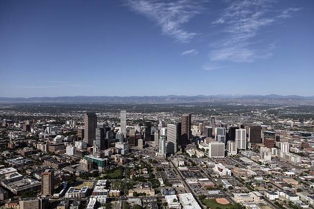 Aerial view of downtown Denver, Colorado with the Rocky Mountains in the distance