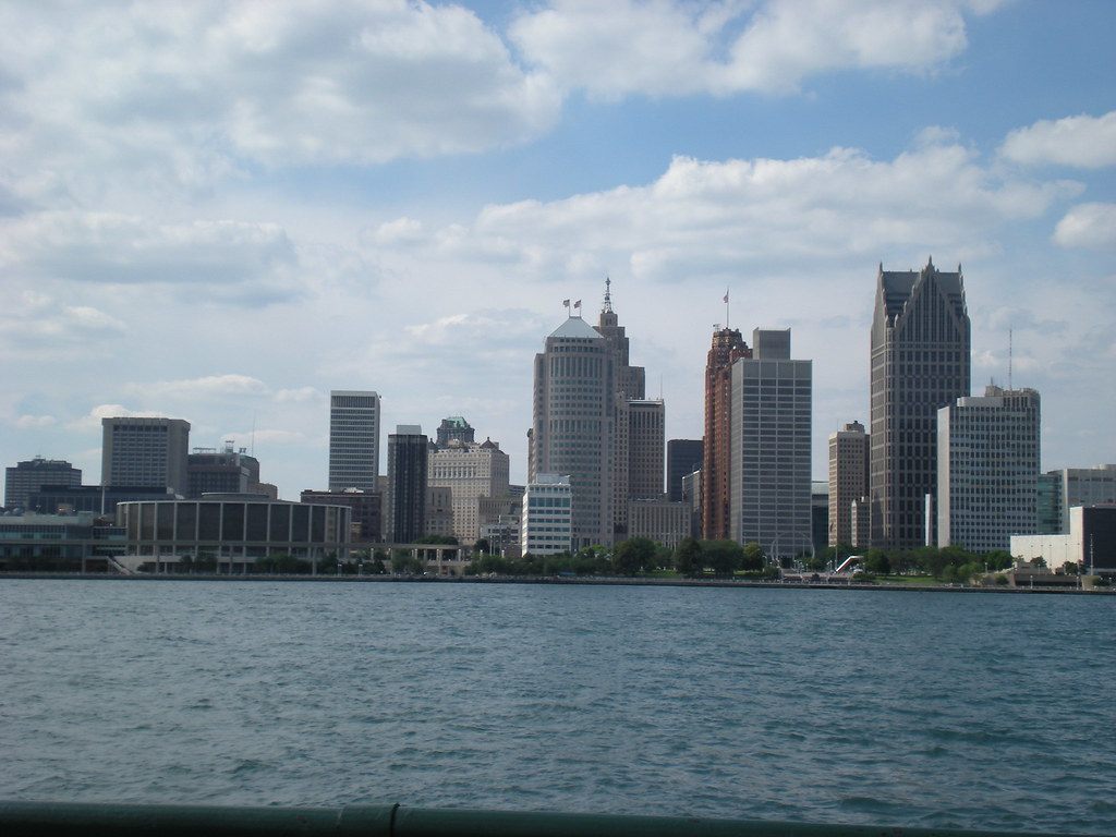 Downtown Detroit seen across the Detroit River, with the round ribbed Cobo Arena on the waterfront at left