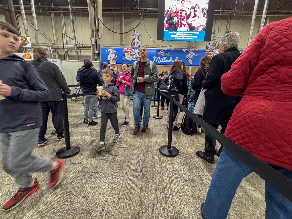 Families lined up between stanchions for milkshakes inside the Farm Show Complex during the 2026 Pennsylvania Farm Show