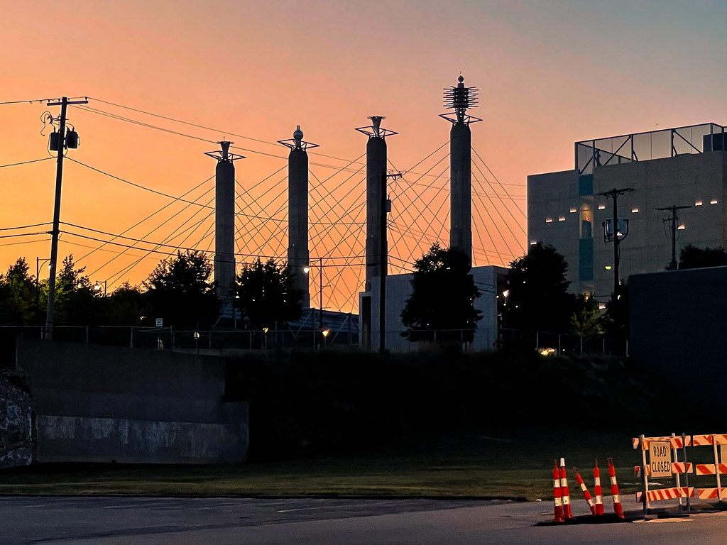 The Bartle Hall pylons and cables silhouetted against an orange sunset sky