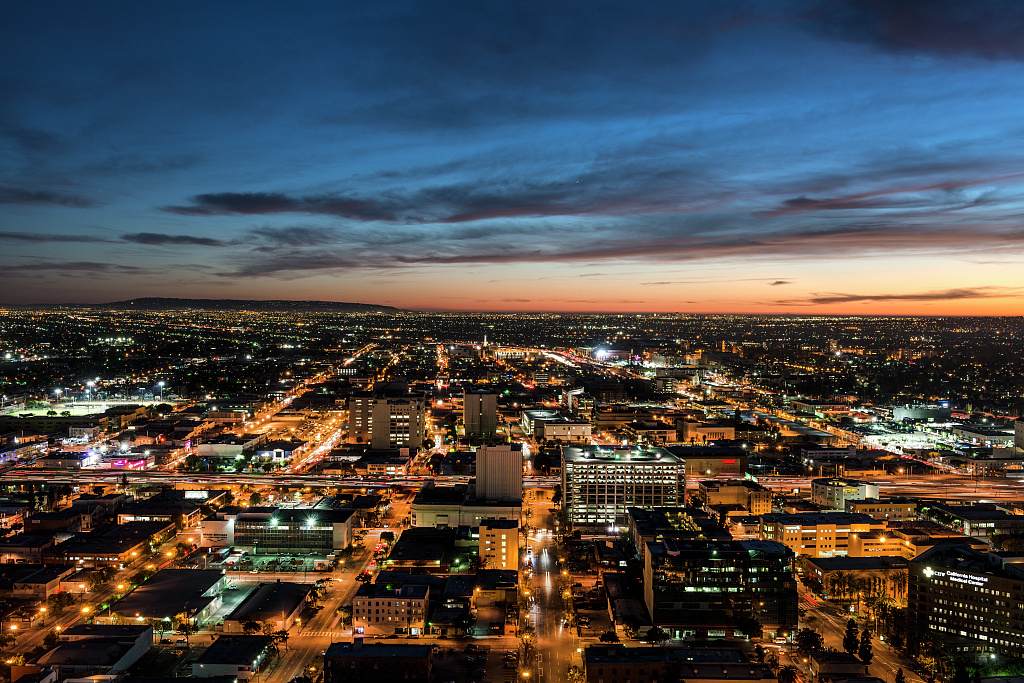 Nighttime skyline view of Los Angeles looking west toward the setting sun