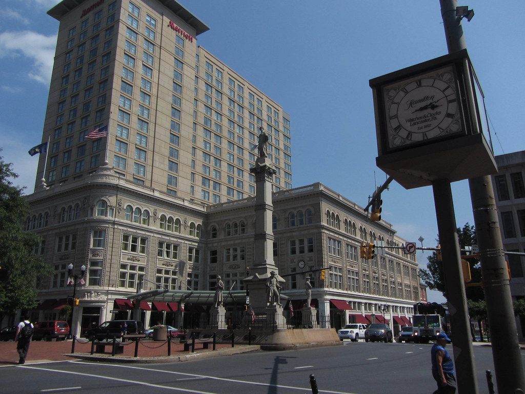 Penn Square with the Soldiers and Sailors Monument, the restored Watt & Shand facade and the Marriott tower behind it