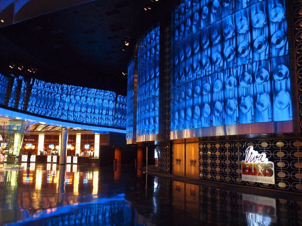 The blue-lit lobby of the Viva Elvis theater at ARIA, with a Cirque du Soleil sign