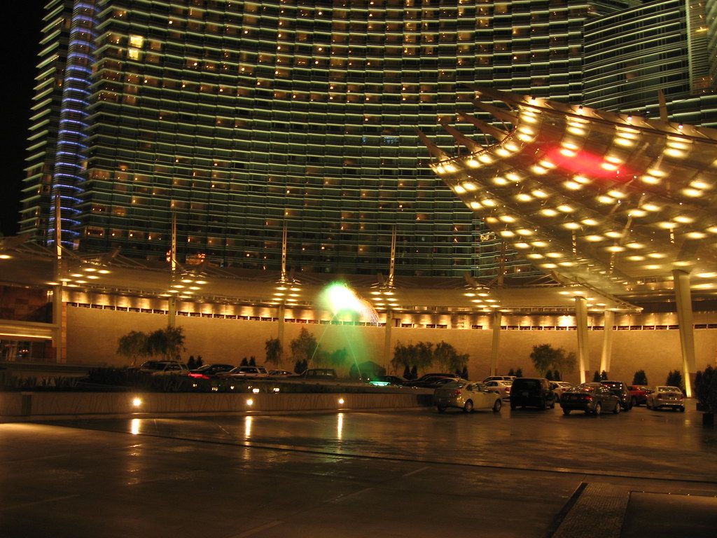 ARIA's main entrance at night, with cars under the lit porte-cochere canopy and the hotel tower above