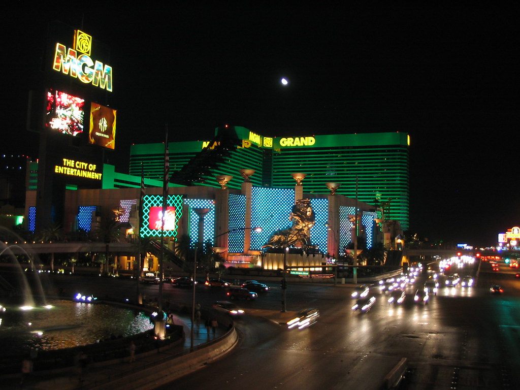 MGM Grand's Strip frontage at night, with the MGM sign, the lion statue and traffic on Las Vegas Boulevard