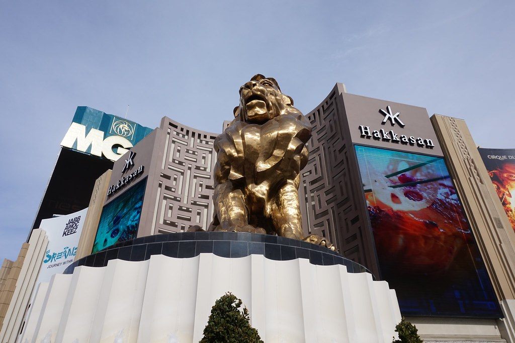 The bronze MGM lion statue on its pedestal in front of MGM Grand, with Hakkasan signage behind