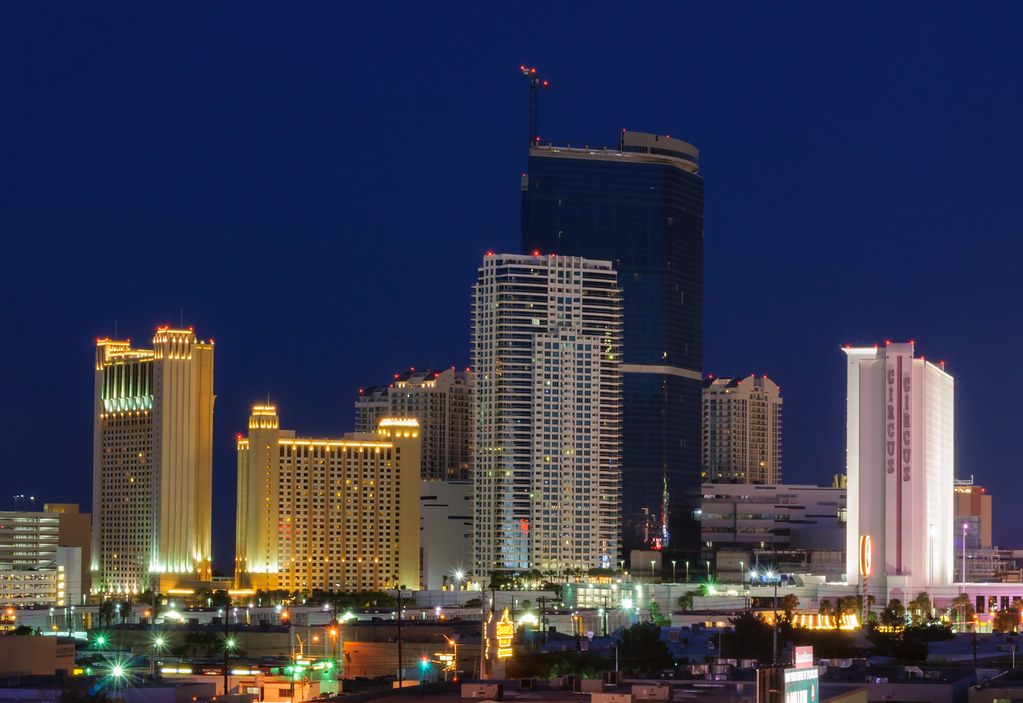 Hotel towers of the north Las Vegas Strip lit up at dusk, with Circus Circus at right