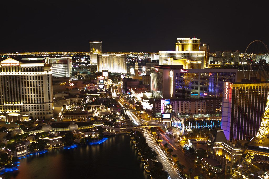 The center of the Las Vegas Strip at night from above, with lit resort towers around the Bellagio lake