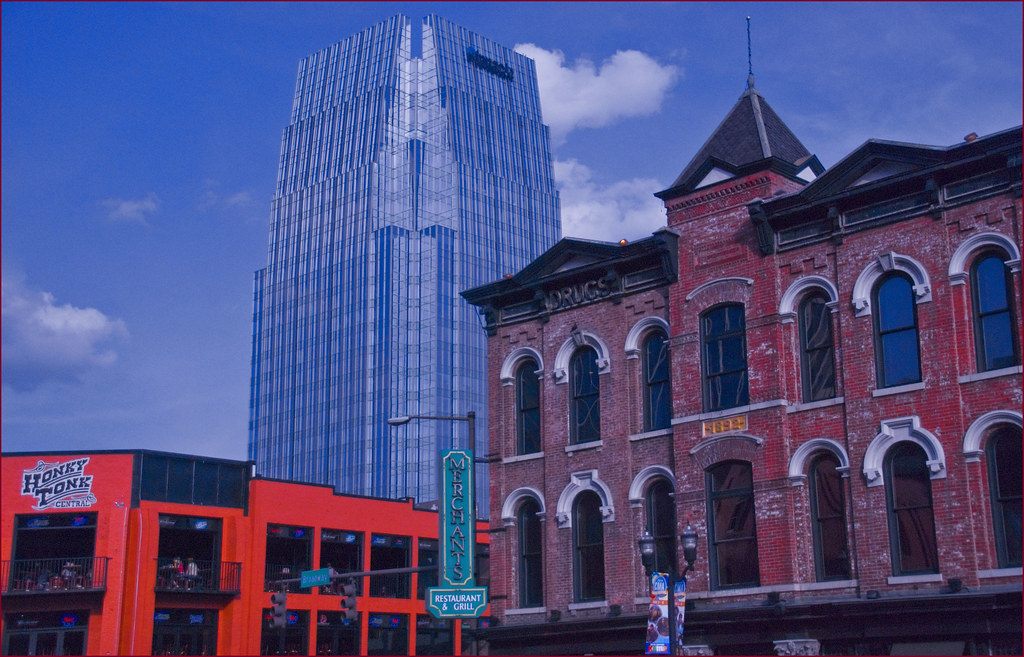 Honky Tonk Central and brick storefronts on Lower Broadway, with the AT&T Building behind