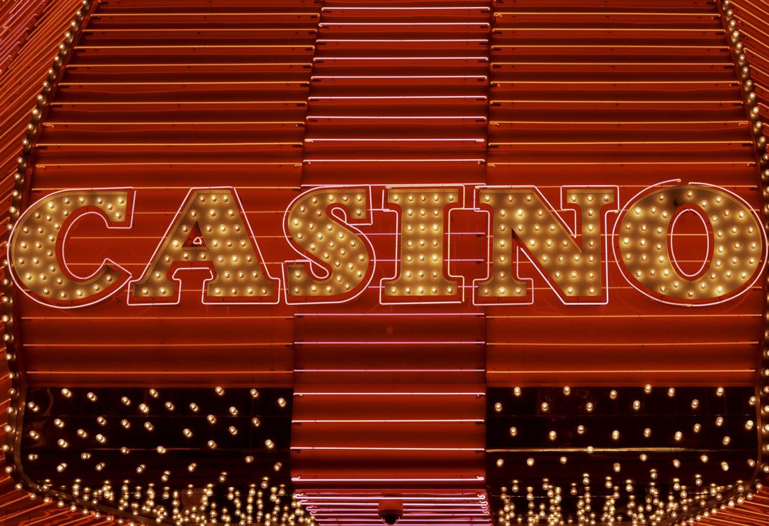A CASINO sign in bulbs and red neon