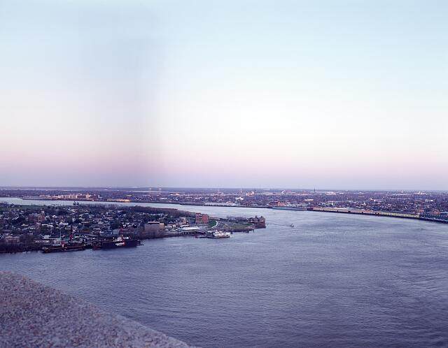 Aerial view of the winding Mississippi River through New Orleans at dusk