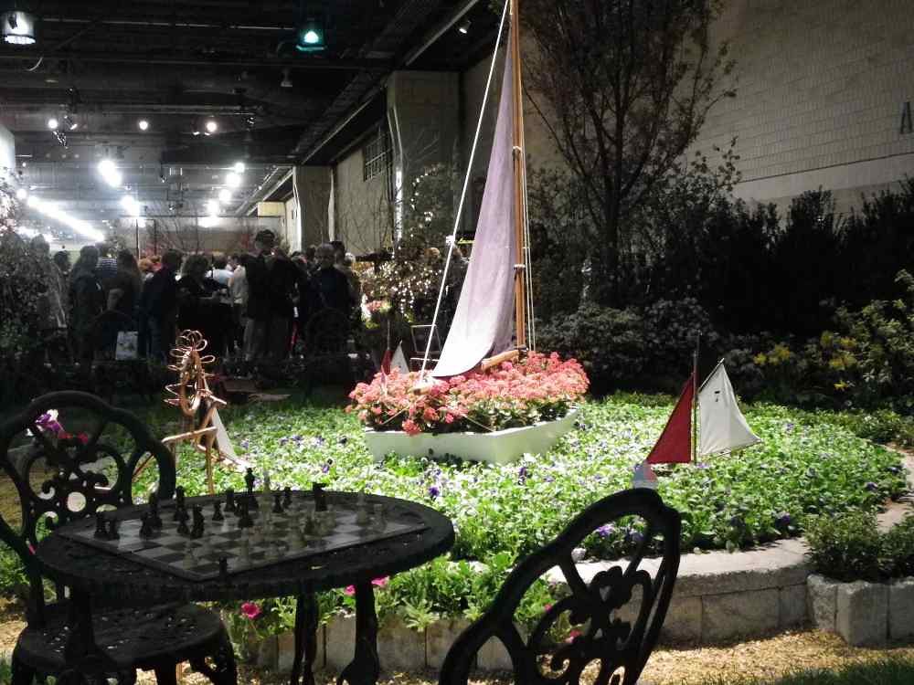 A garden display with a boat pond and sailboats at the 2011 Philadelphia Flower Show inside the convention center