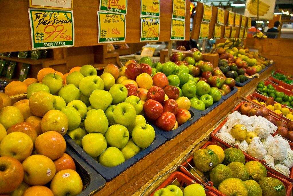 Apples, oranges and other fresh produce stacked at a stand in the Reading Terminal Market