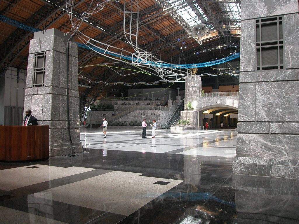 The polished stone floor and granite piers of the convention center's Grand Hall under the high arched roof of the old Reading Railroad train shed