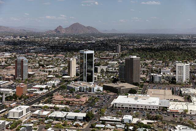 Aerial view of downtown Phoenix, Arizona with pockets of tall buildings along Central Avenue