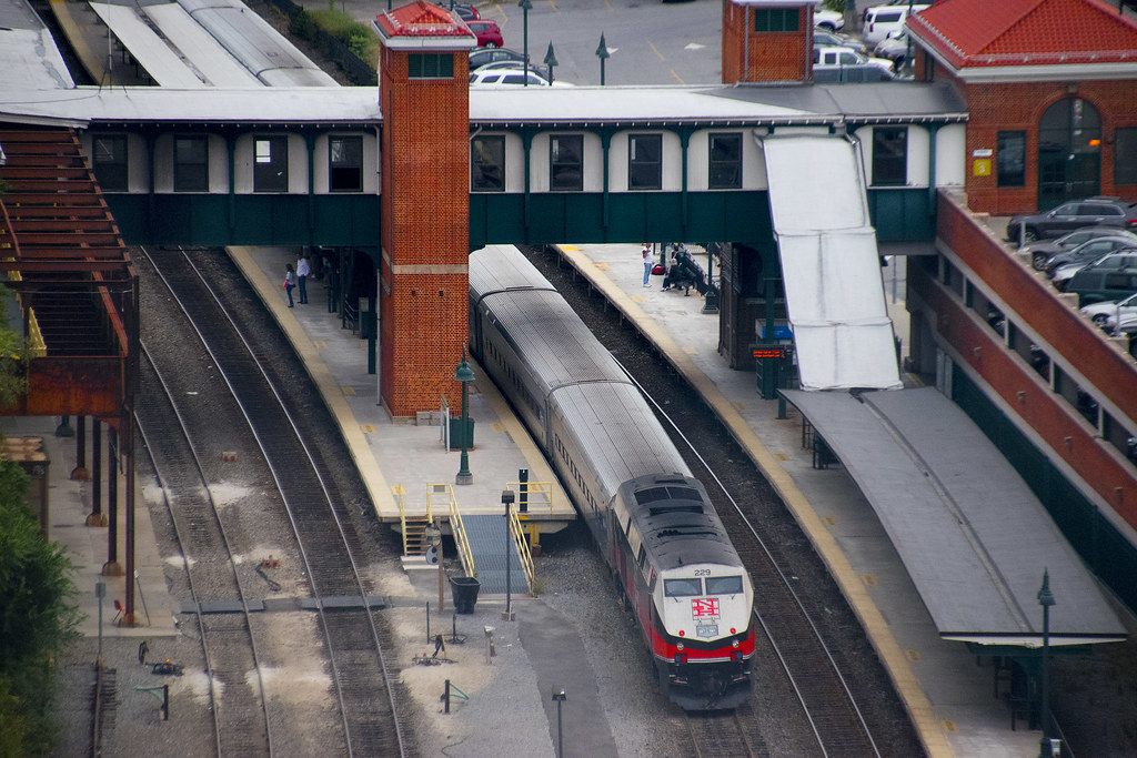 A Metro-North train at the platforms of the brick Poughkeepsie station, seen from above