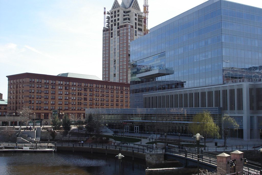 WaterPlace Park on the river in downtown Providence, with a glass office building and brick buildings behind