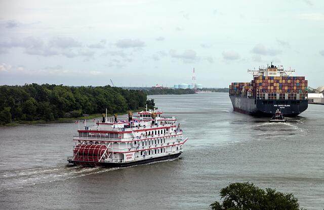 The Georgia Queen paddlewheel riverboat and a container ship on the Savannah River