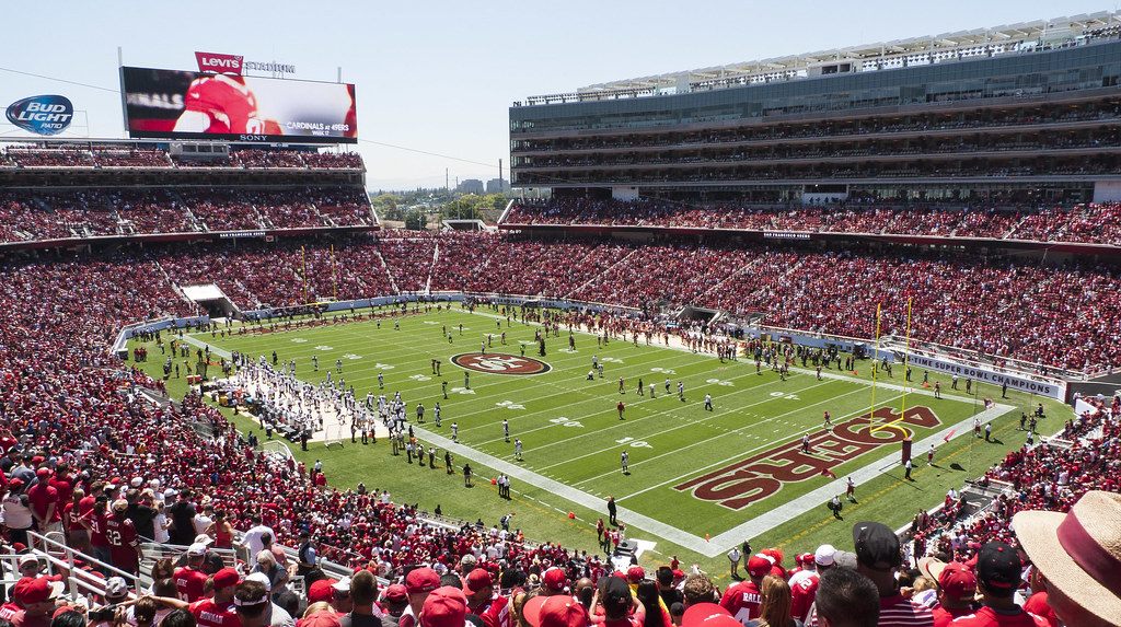 A packed Levi's Stadium in red seats around the 49ers field on opening day, seen from the upper stands