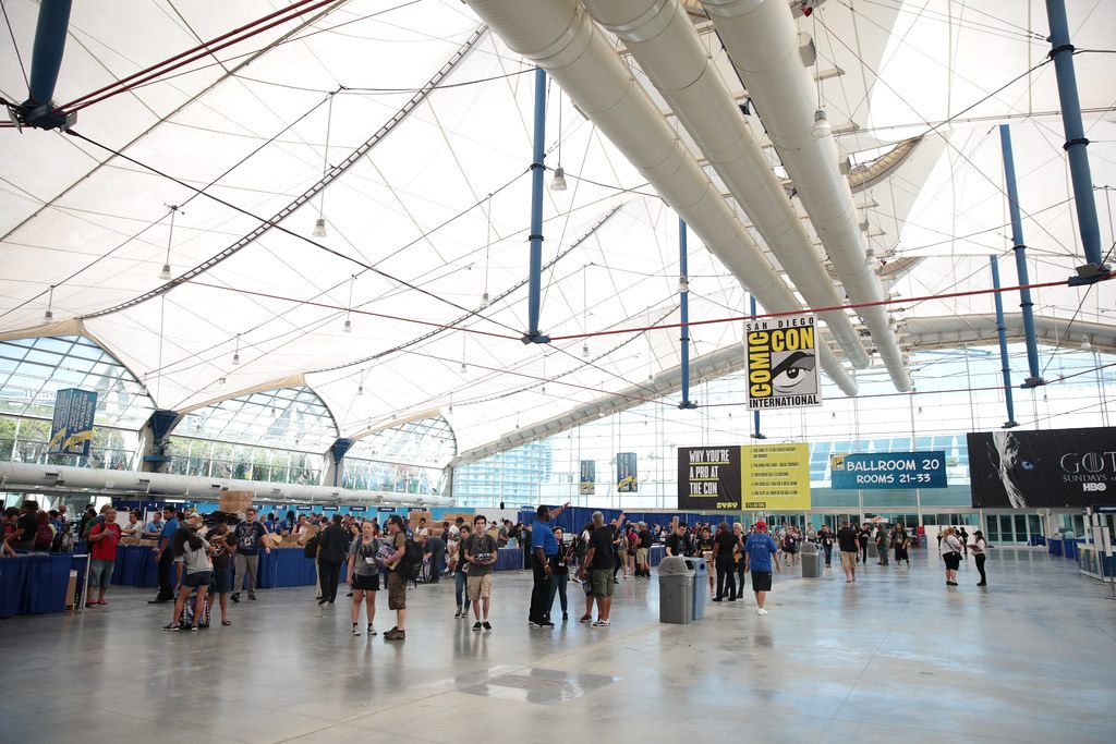 Attendees walking under the white tent roof of the Sails Pavilion at the San Diego Convention Center during Comic-Con