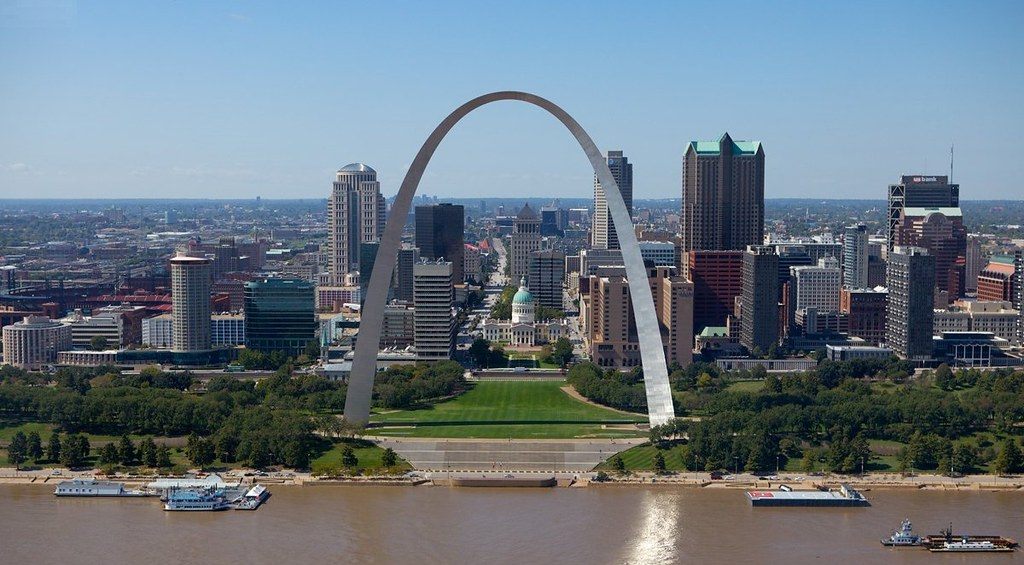 The Gateway Arch over the Mississippi riverfront with the downtown St. Louis skyline and the domed Old Courthouse behind it