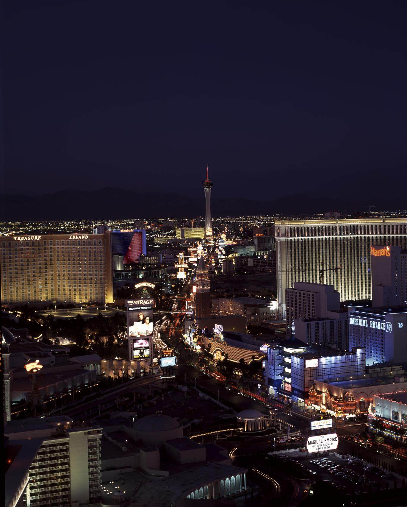 Night aerial view of the Strip with Treasure Island, the Mirage, the Venetian campanile and Harrah's