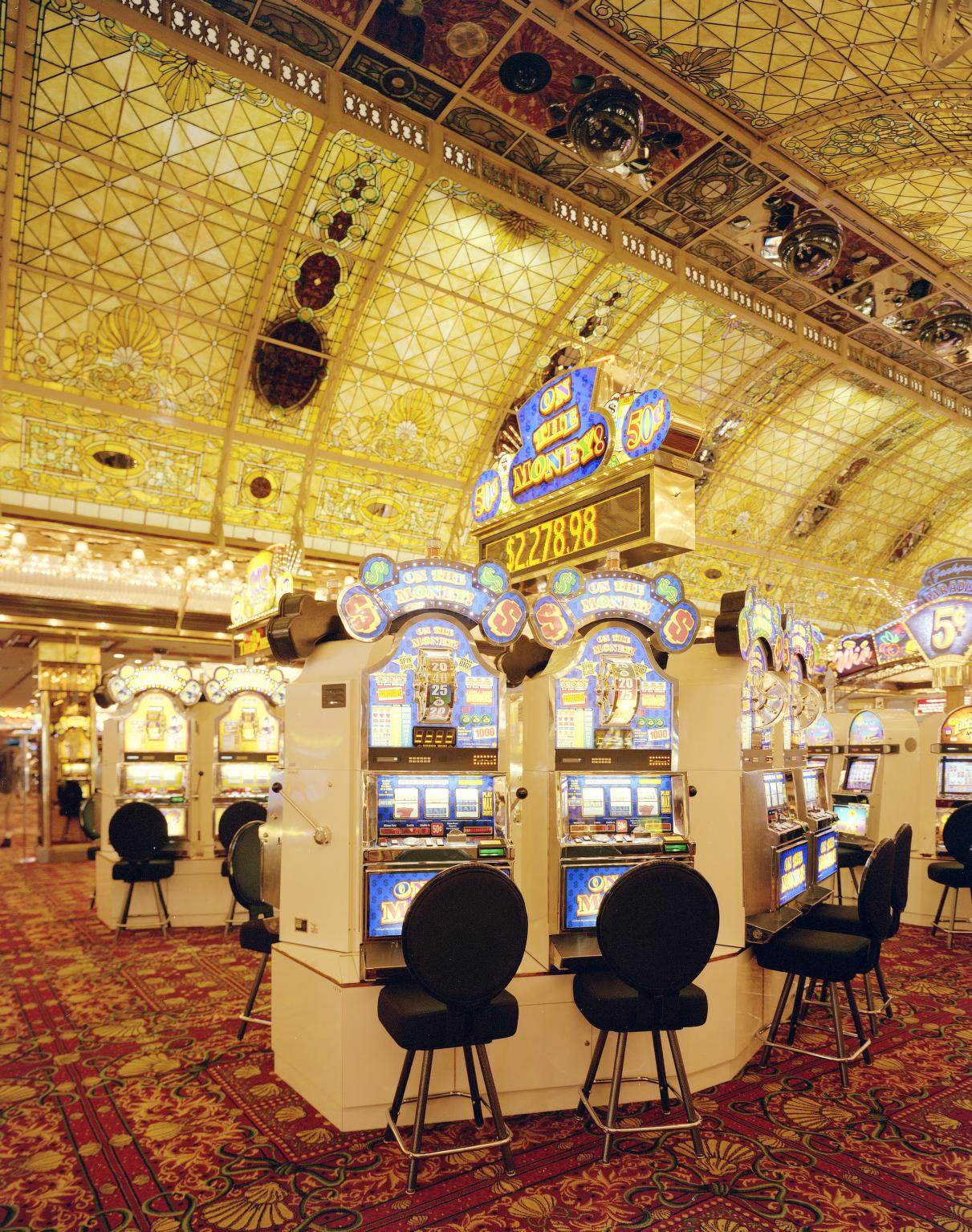 Slot machines under a stained-glass ceiling inside the old Tropicana casino