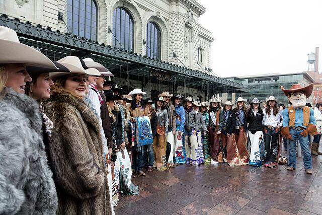 Rodeo queens and the Howdy mascot pose outside Denver's Union Station before the National Western Stock Show kickoff parade