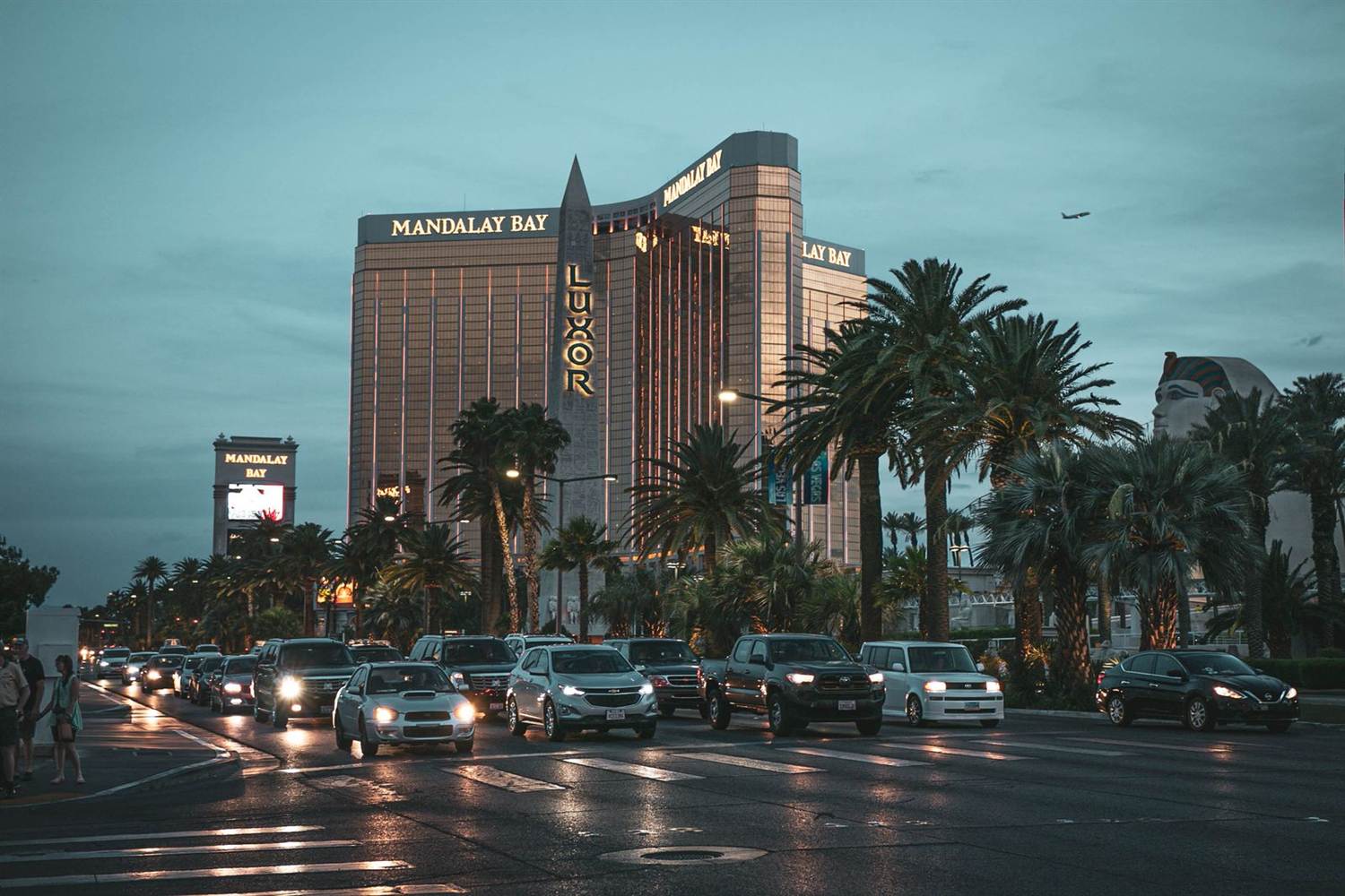 Mandalay Bay and Luxor at dusk with traffic on the Strip