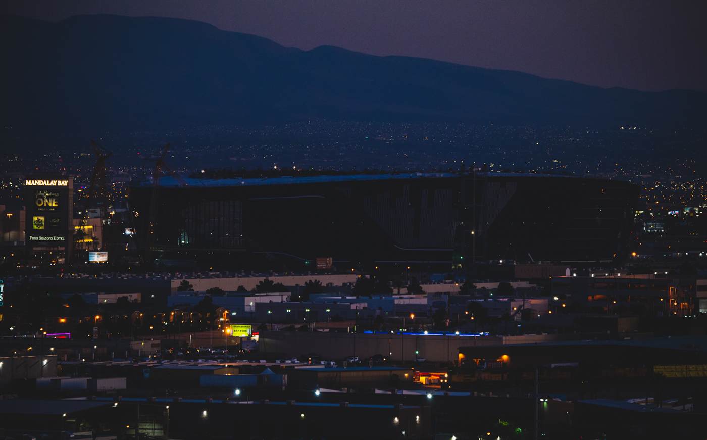 Allegiant Stadium under construction in January 2020 with the Mandalay Bay tower behind it