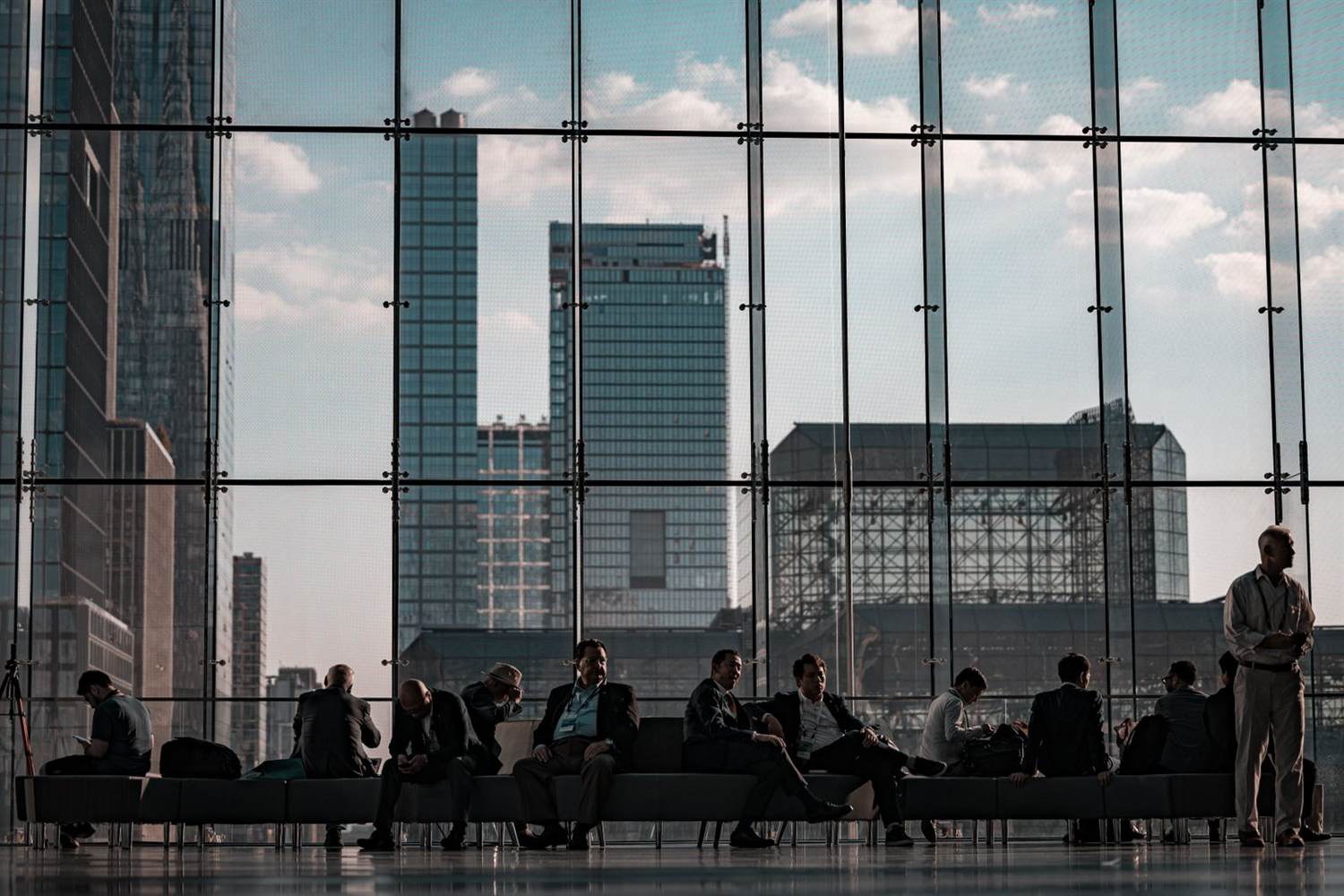 Business professionals walking through the Javits Center concourse during a show