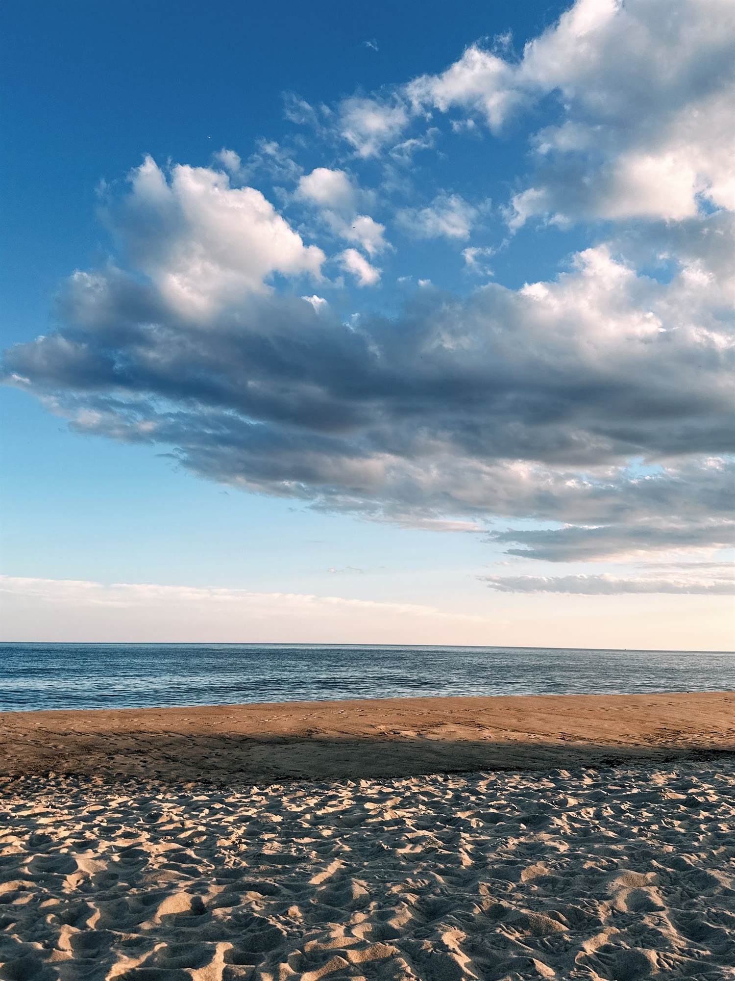 A calm beach at Montauk on Long Island under a wide sky