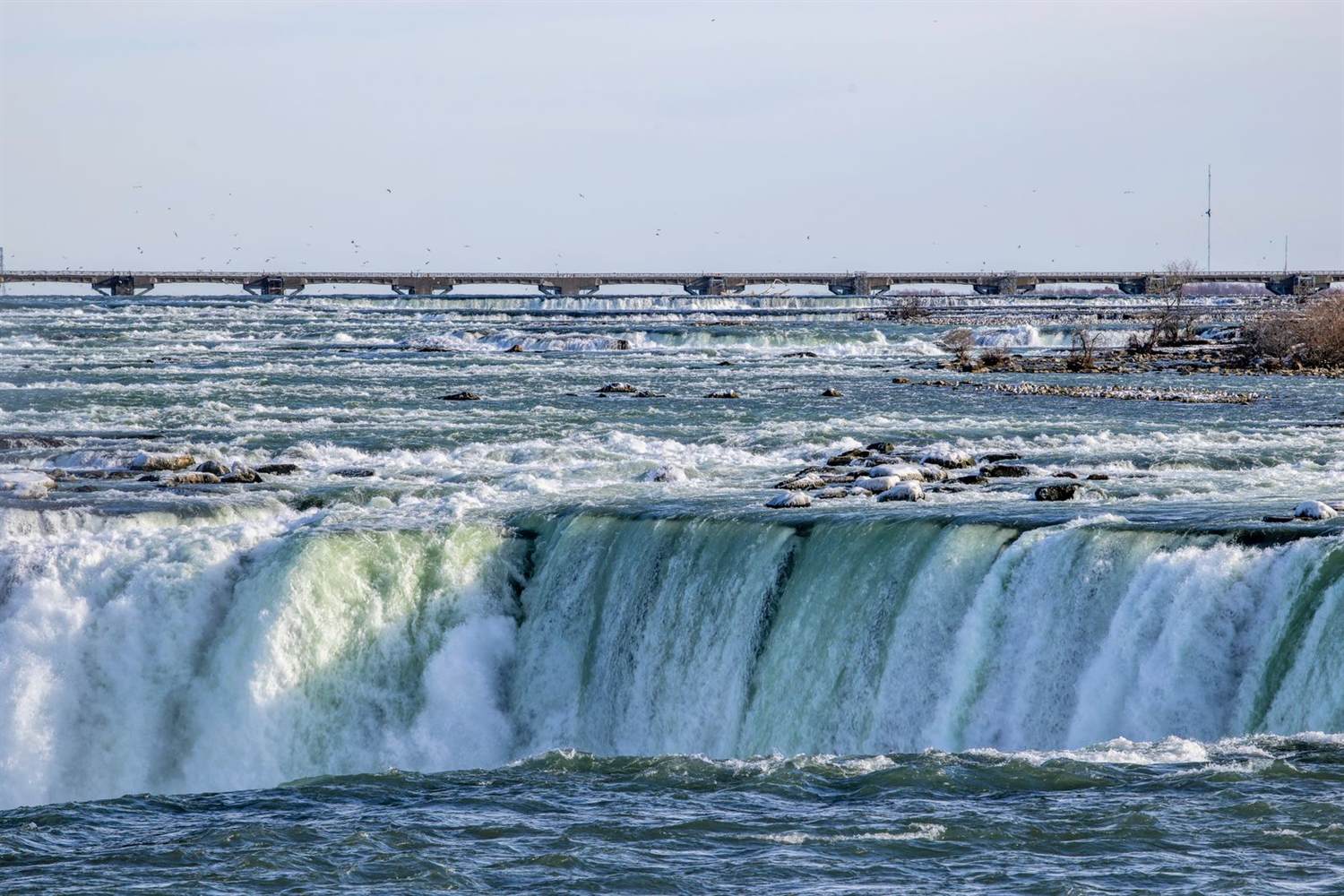 Niagara Falls with a distant bridge
