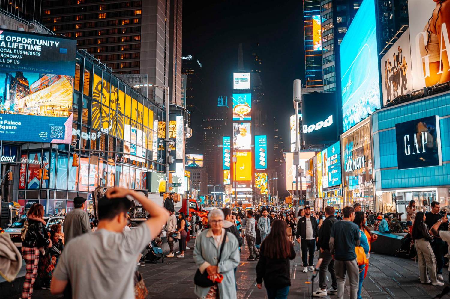 Times Square at night with crowds and illuminated billboards