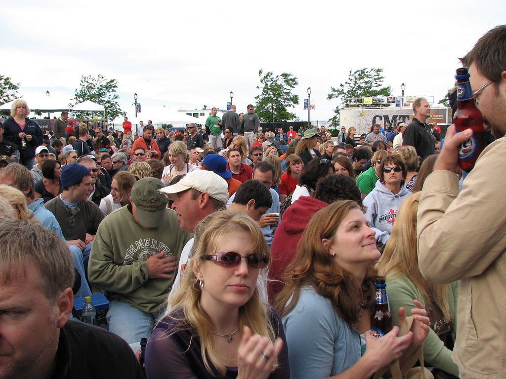 A dense festival crowd in sweatshirts and caps in front of a lakefront stage at Summerfest 2007 in Milwaukee