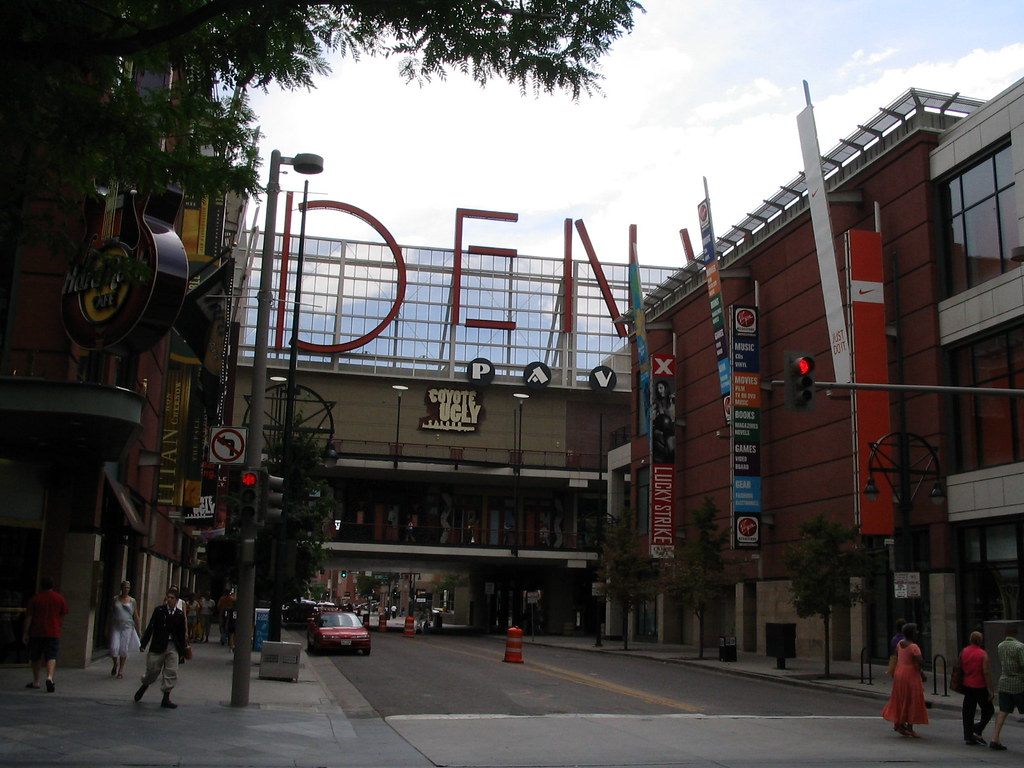 Pedestrians on a downtown Denver street seen from the 16th Street Mall toward the convention center district