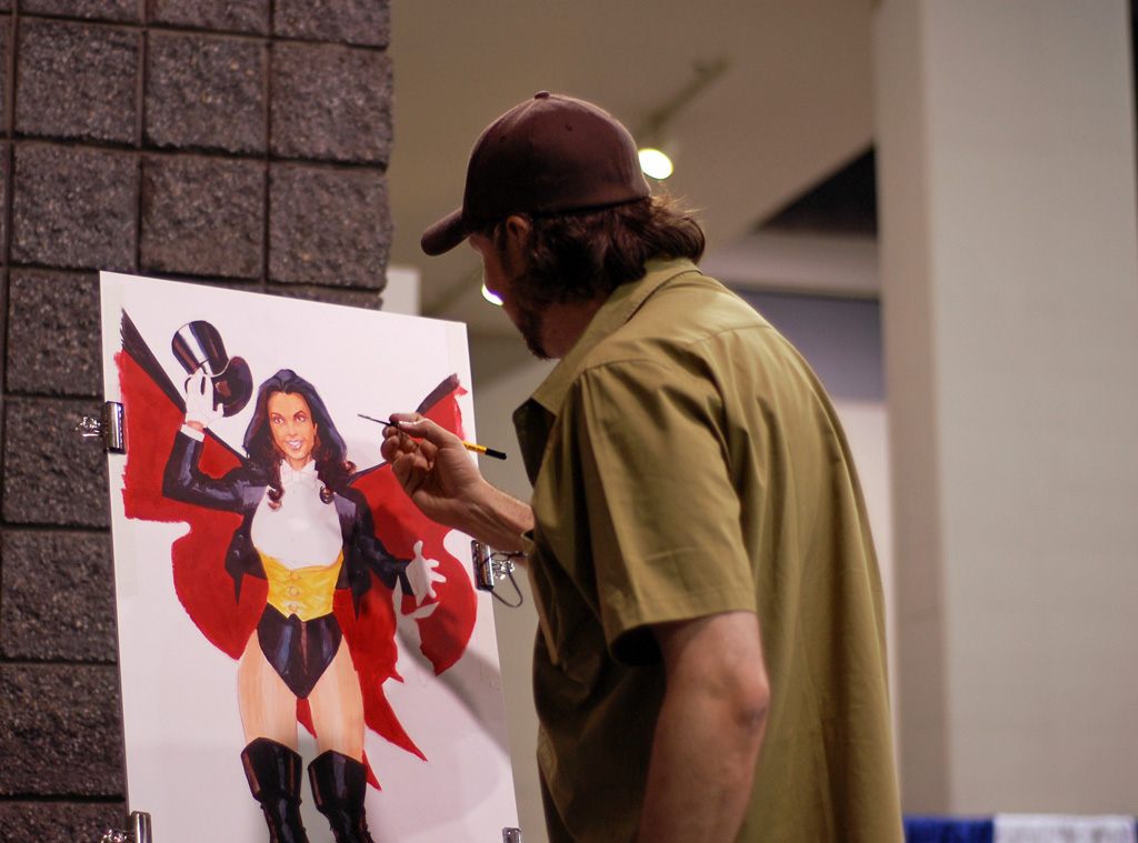 An artist painting a Zatanna illustration on an easel at Heroes Con 2009 in Charlotte