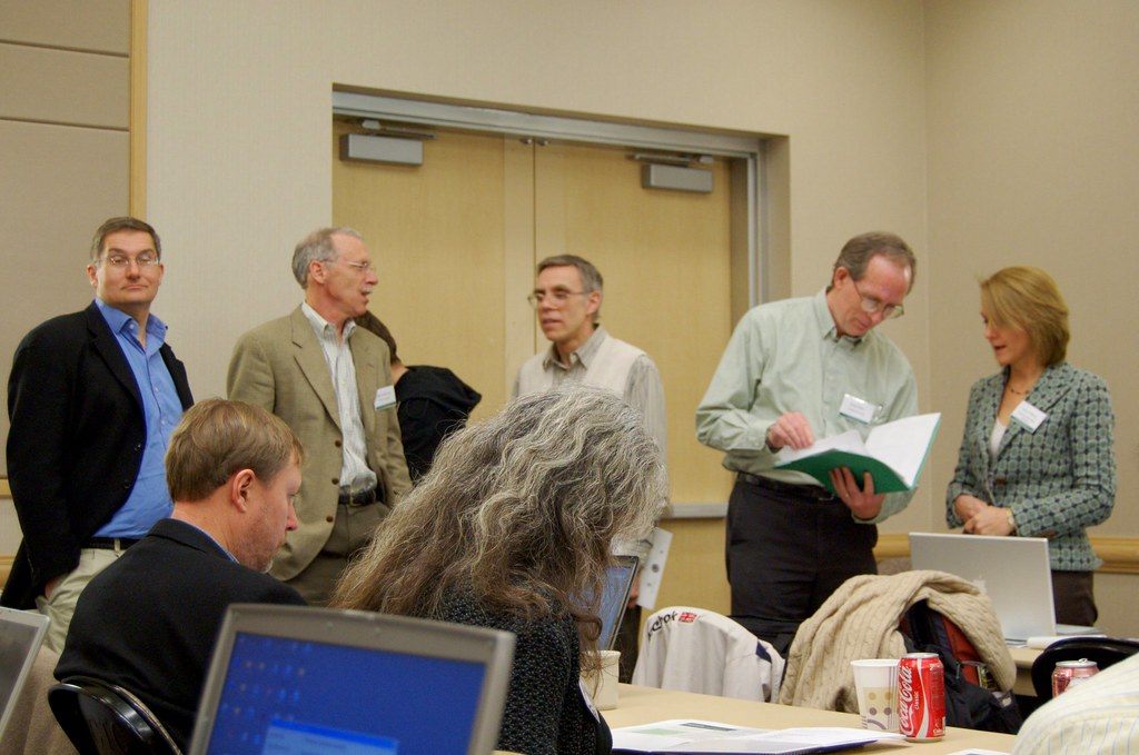 Computer science educators with laptops and papers talk between sessions at the SIGCSE 2009 conference in Chattanooga