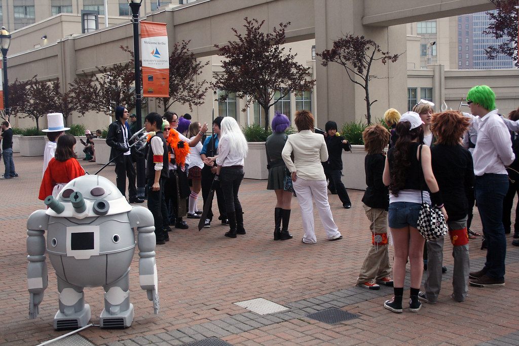 Crowds of costumed ConnectiCon attendees gathering on a brick plaza in downtown Hartford